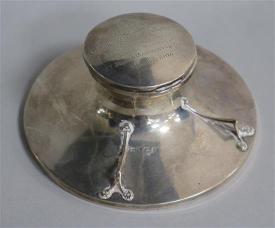 An Edwardian silver mounted capstan inkwell with pen rest, William Adams, Ltd, Birmingham, 1905, 14cm.